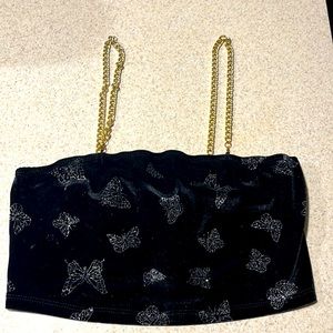 Front/Back it’s a soft black crop top with silver butterflies and gold chains